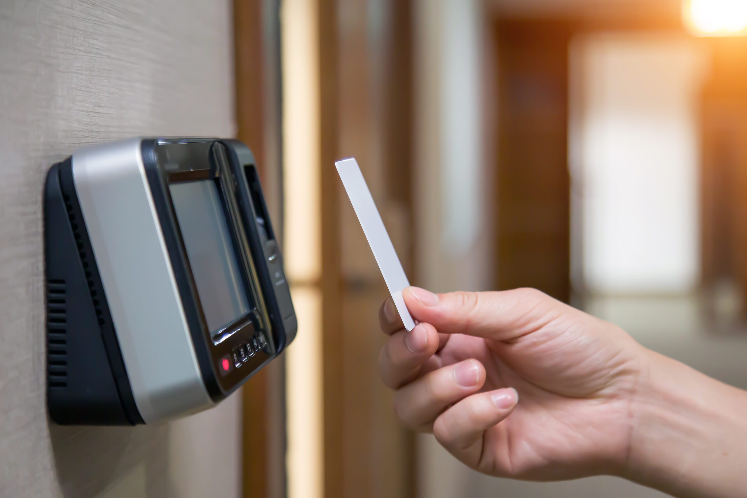 Office man using the id card to scan at the access control system machine for check attendance and open the security door.